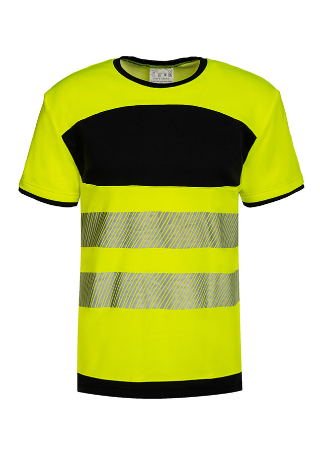 Erwachsener in signalgelbem Korntex-T-Shirt mit schwarzer Brustpartie und Reflexstreifen in einem industriellen Umfeld