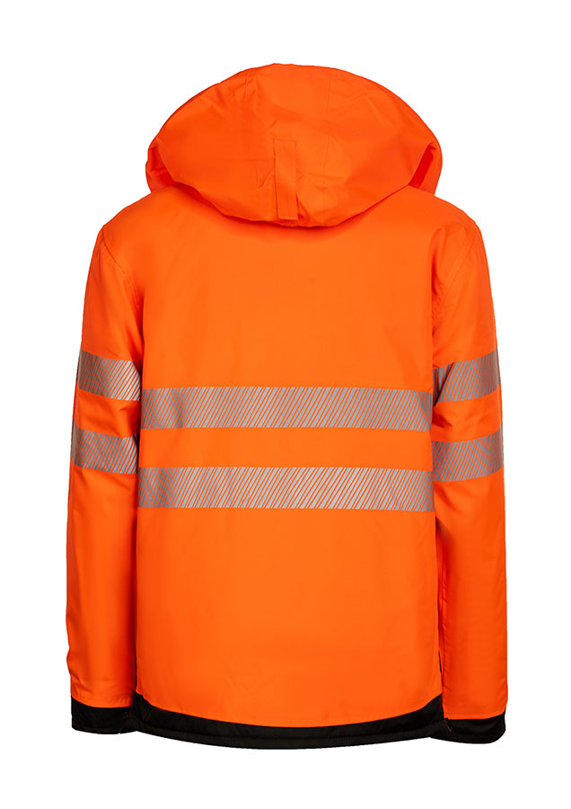 Erwachsener in signalgelbem Korntex-Parka mit schwarzer Brustpartie und Reflexstreifen in einem industriellen Umfeld