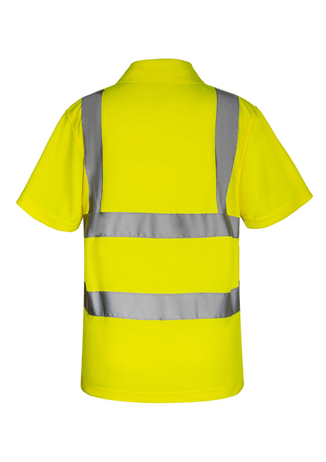 Erwachsener Bauarbeiter steht in fluoreszierendem gelben Korntex Polo-Shirt mit Funkgerät vor einem zerstörtem Gebäude