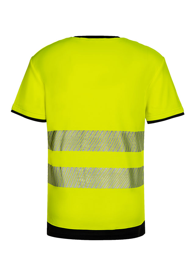 Erwachsener in signalgelbem Korntex-T-Shirt mit schwarzer Brustpartie und Reflexstreifen in einem industriellen Umfeld